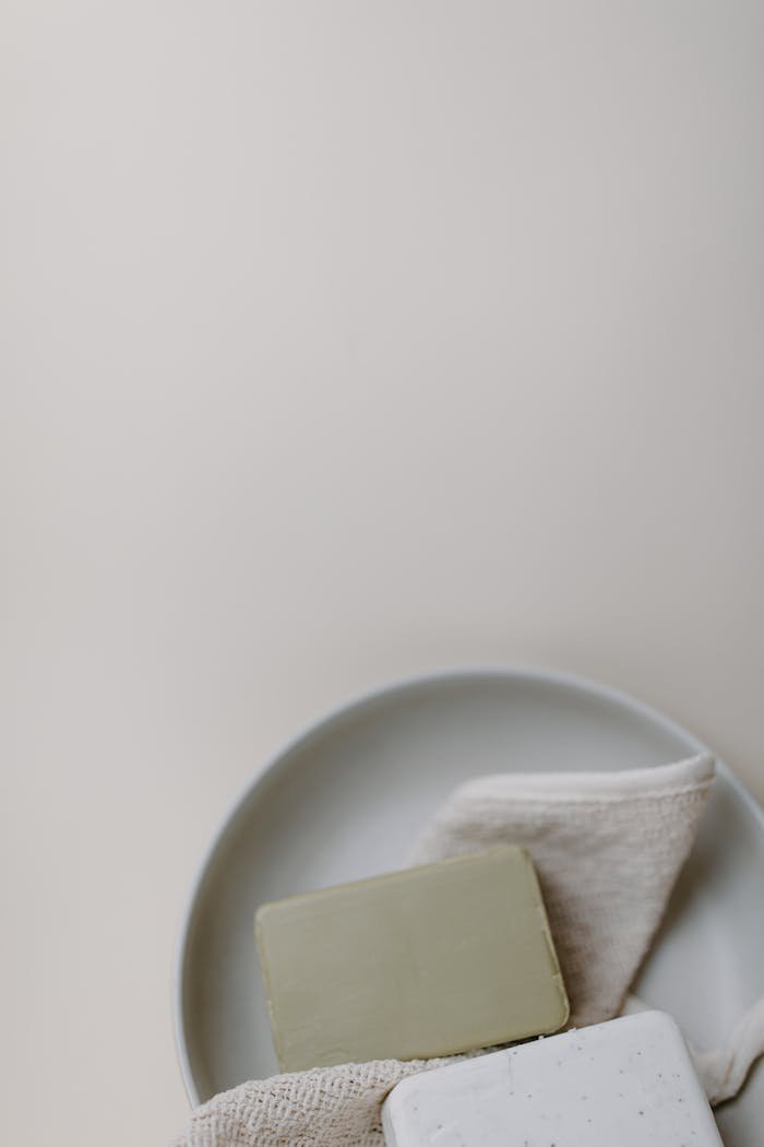 Flat lay image featuring natural soap bars on a neutral background, promoting eco-friendly hygiene.