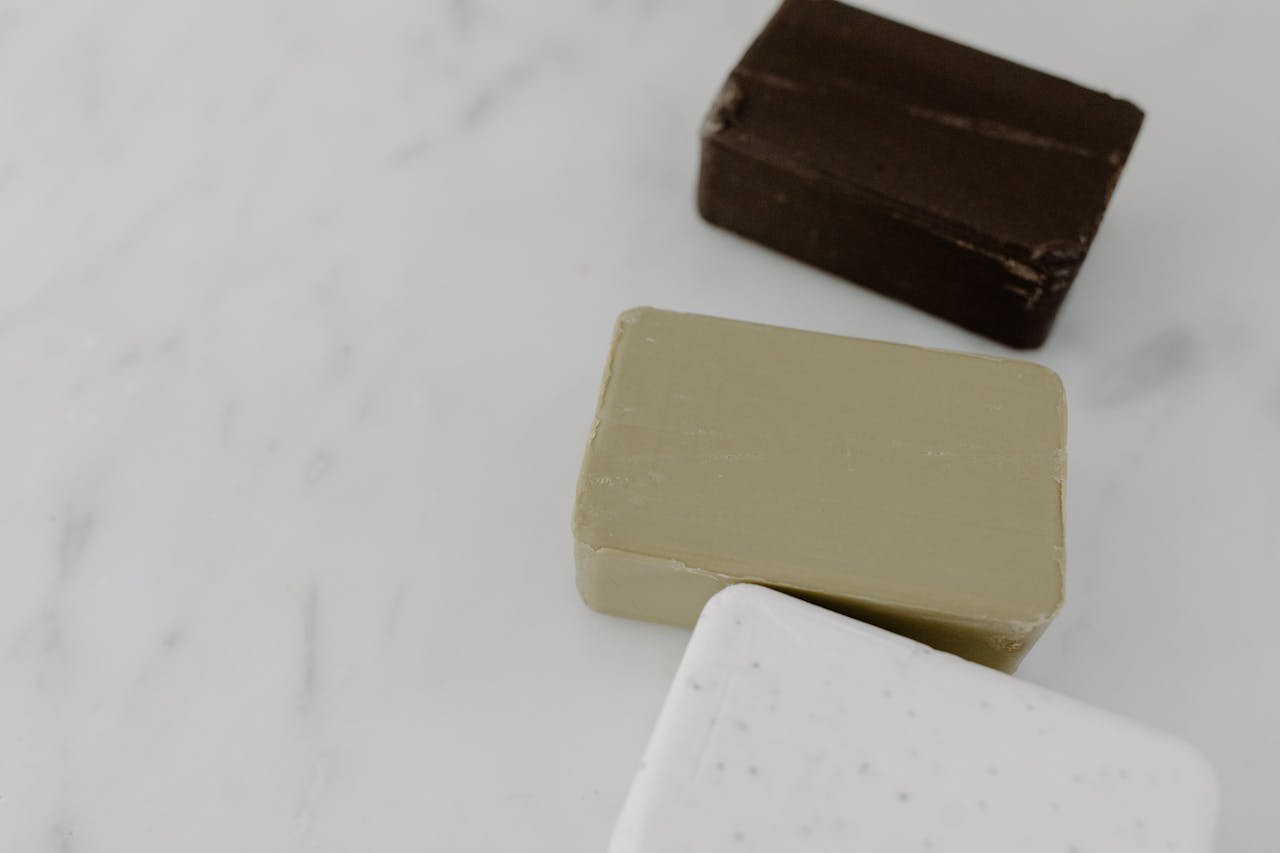about-us High-angle view of assorted bar soaps on marble, perfect for beauty and cosmetic themes.